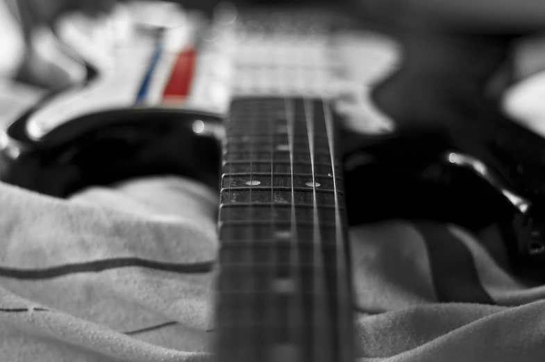 a person laying on a bed with a guitar