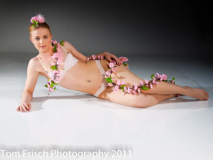 a  woman wearing flowers is on the floor