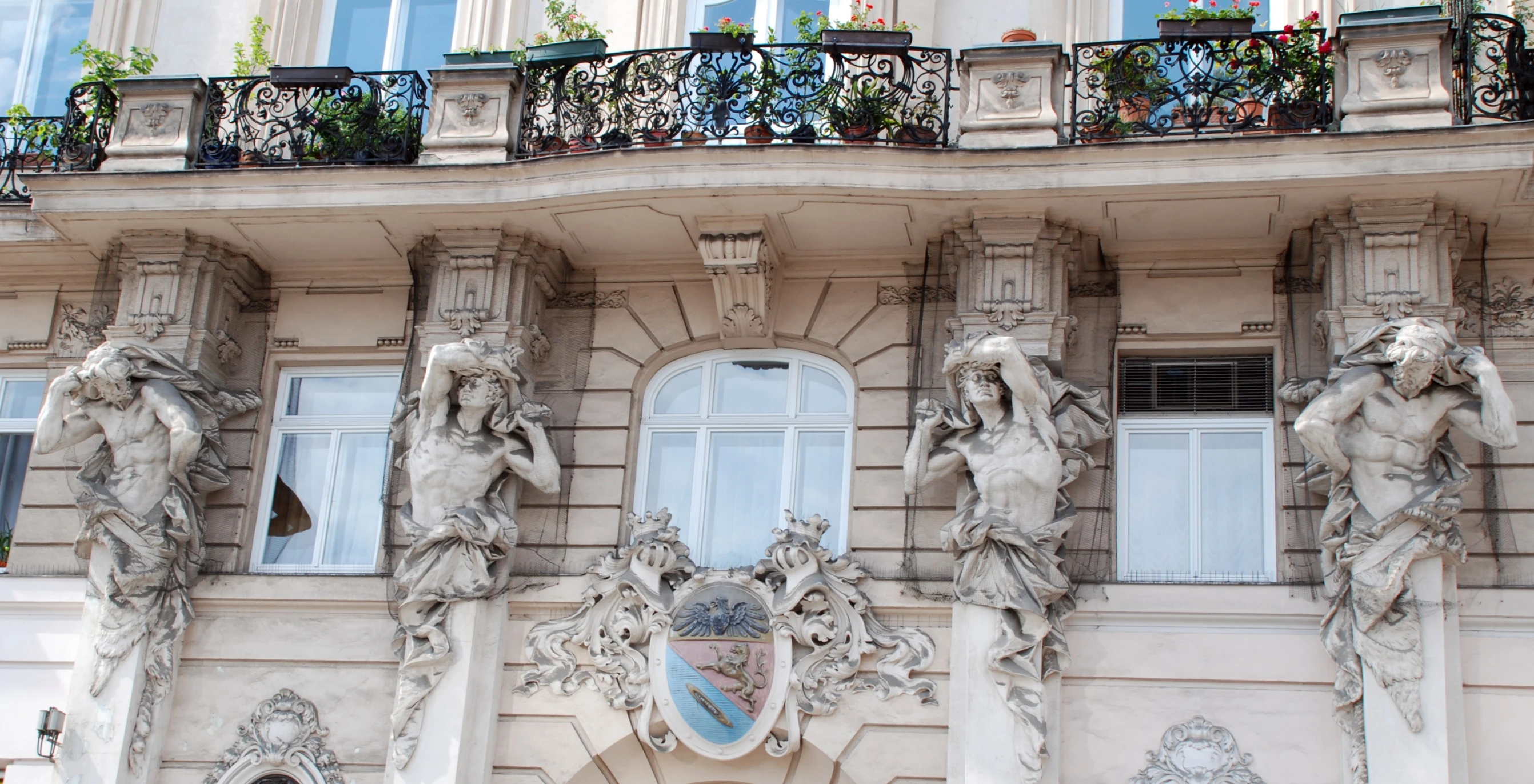 many small statues on top of each other by an old building