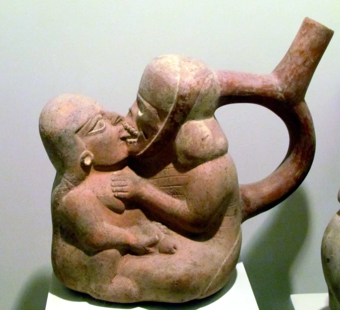 a pitcher with a woman holding a boy