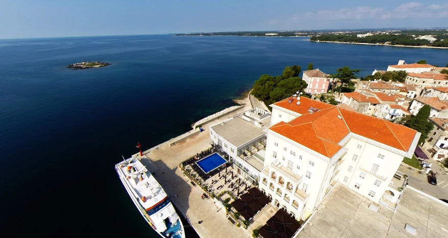 an aerial view of a large building on the water