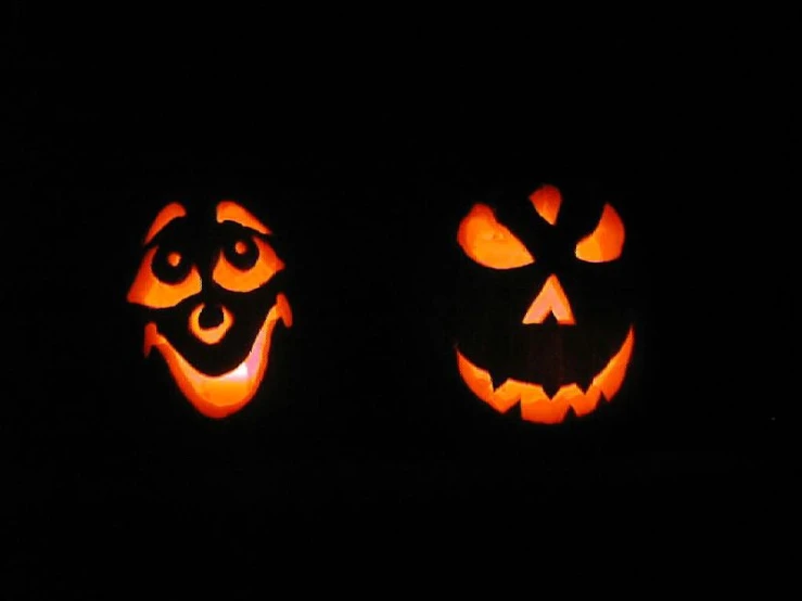 there are two pumpkins that look like jack - o'- lanterns