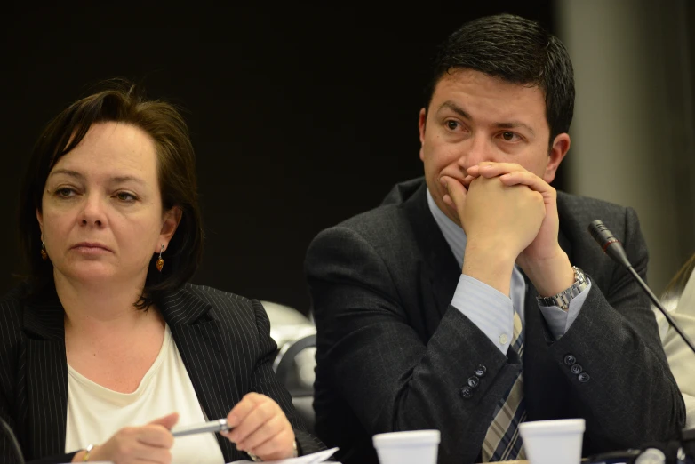 two people sitting next to each other at a table