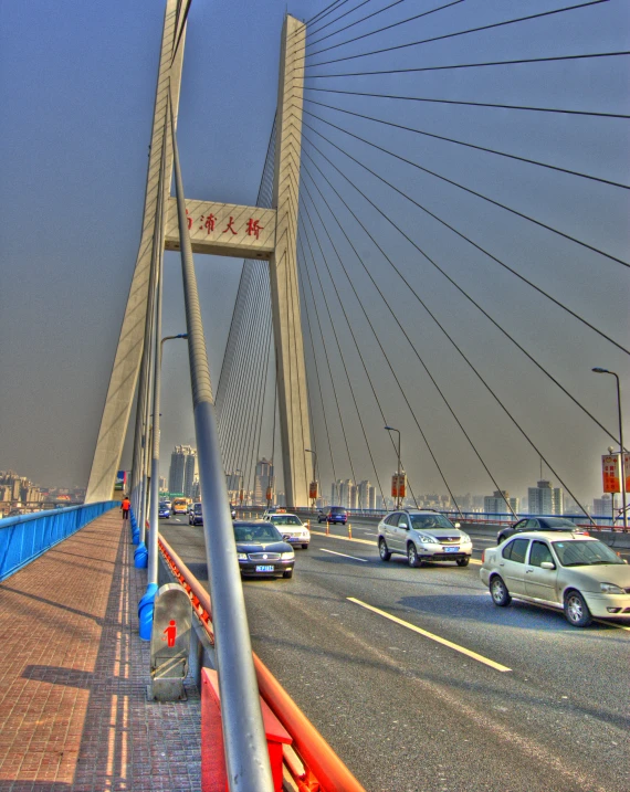 a long, metal, pedestrian bridge on the side of a road