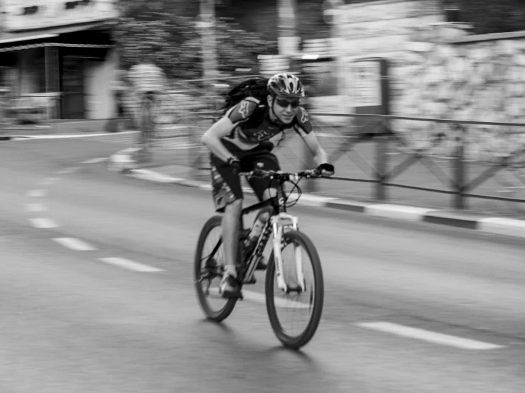 a black and white po of a bicyclist riding in an olympics event