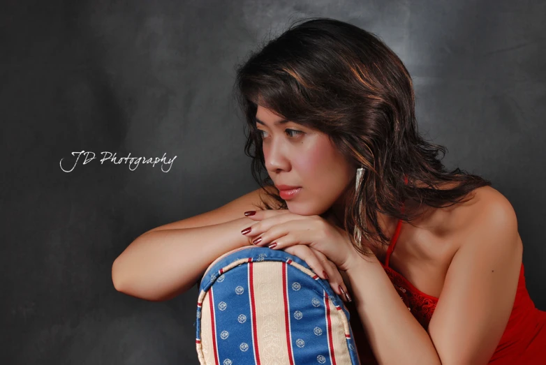 a woman holding a red, white and blue backpack