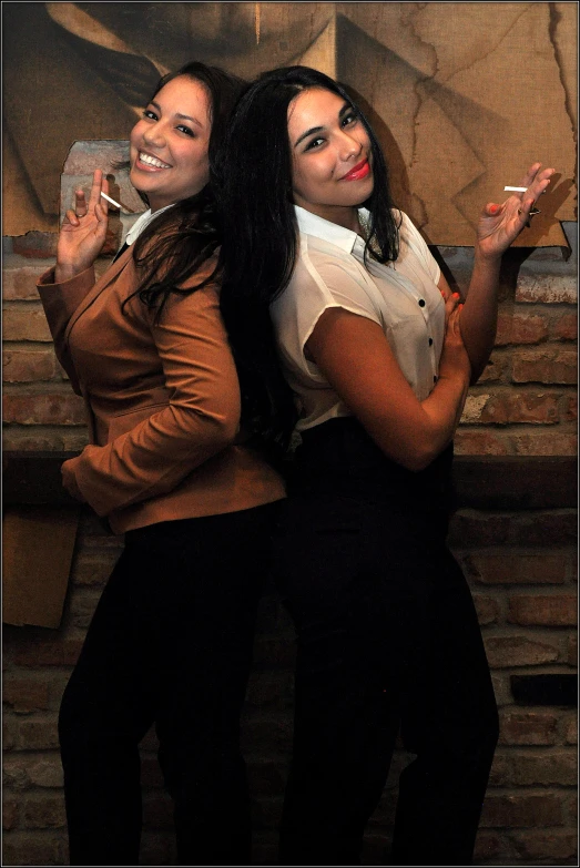 two women with black hair and white shirts smoking