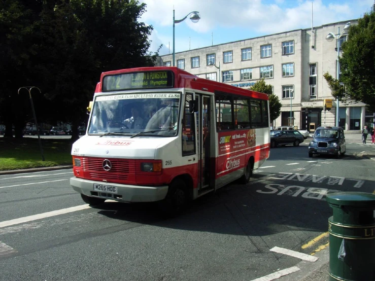 a white and red bus traveling down the road