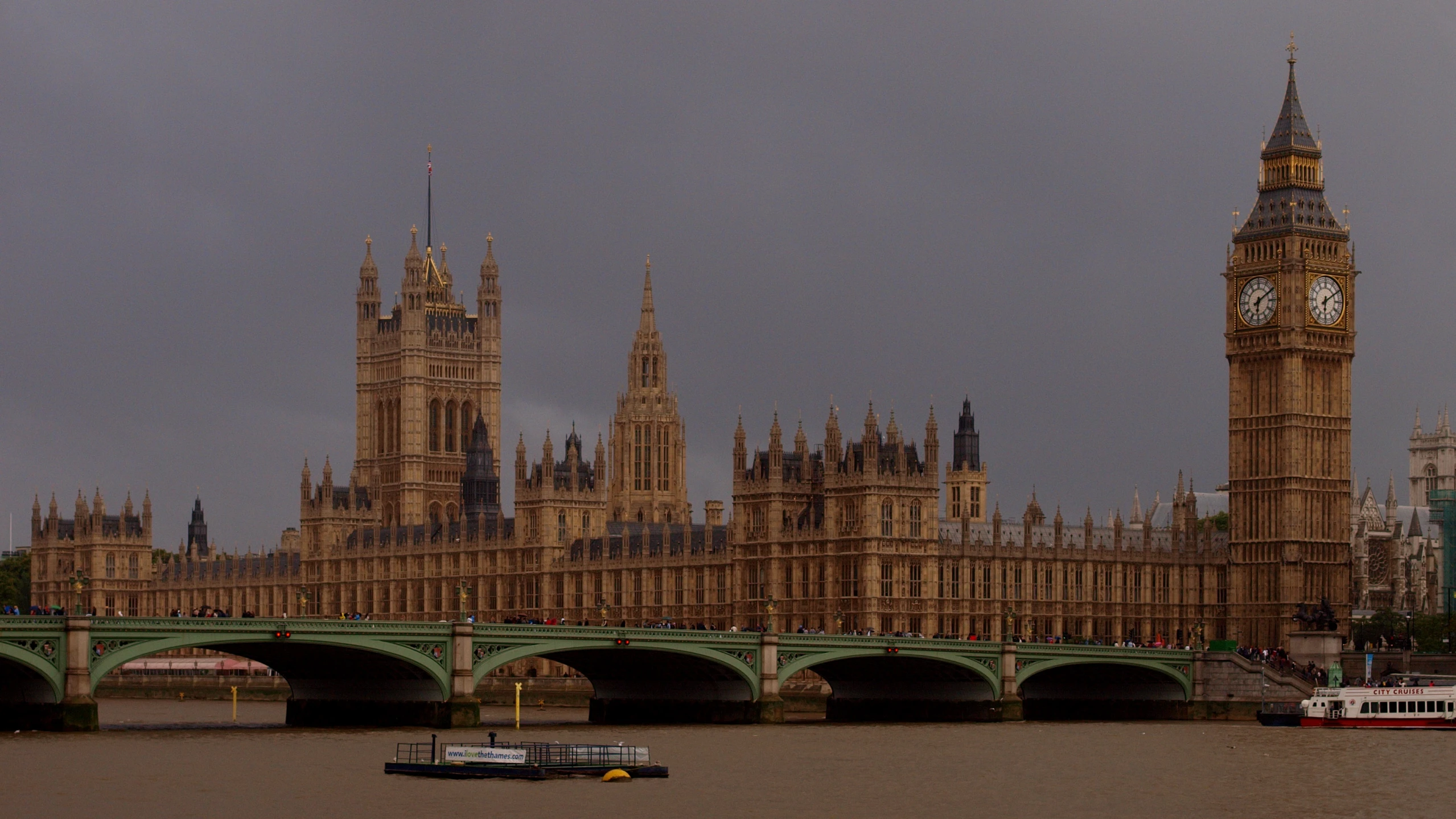 the big ben clock tower towering over london next to the river thames