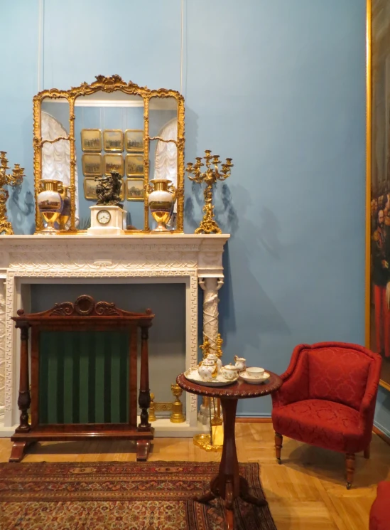 a living room with a fireplace and chairs