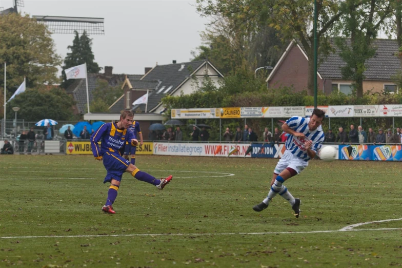 some people playing soccer against each other on a field