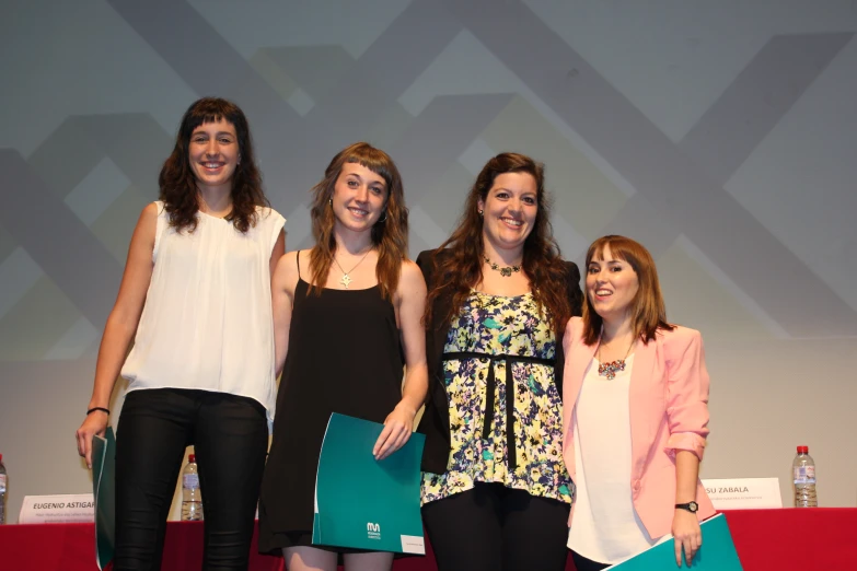 a few girls posing in front of a screen