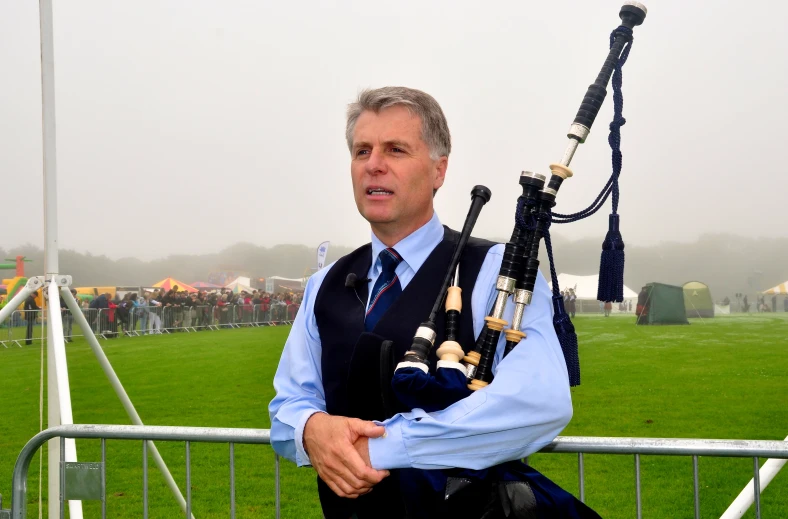 a man playing bagpipes on the side of the road