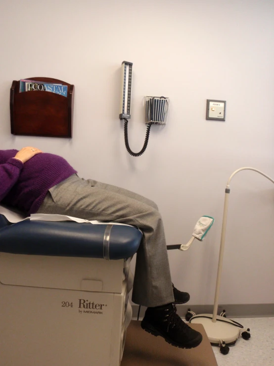 a person laying down on a table in a doctors office