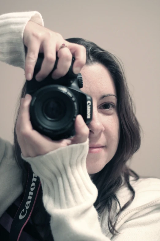 a woman is taking a picture with her camera