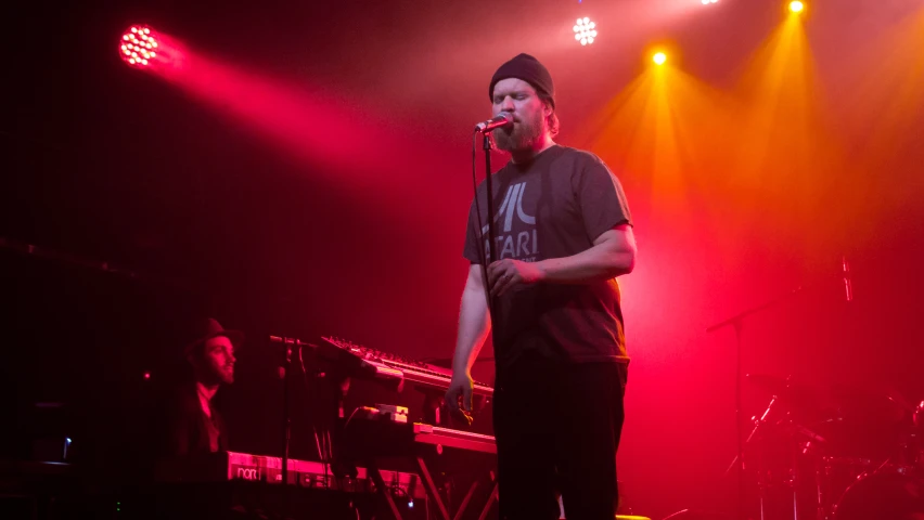 a man is standing up in front of microphones