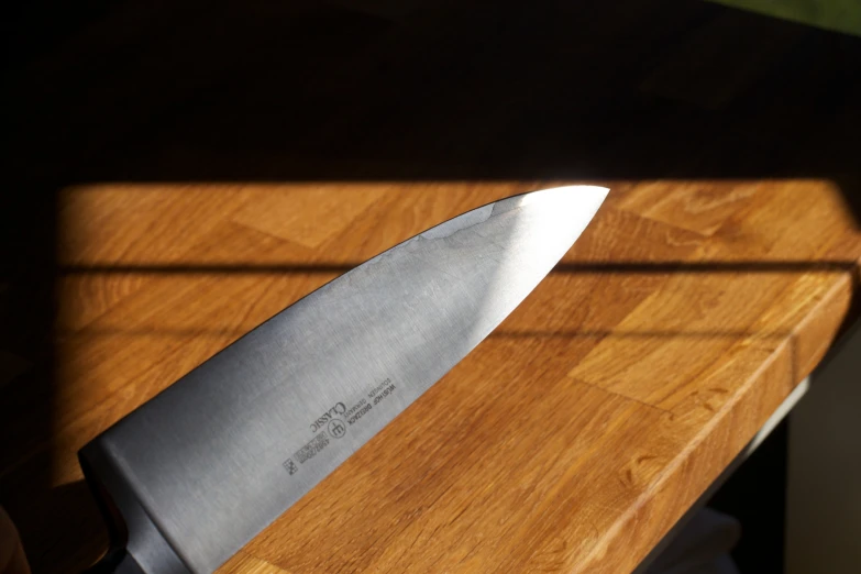 a kitchen knife sitting on top of a  board