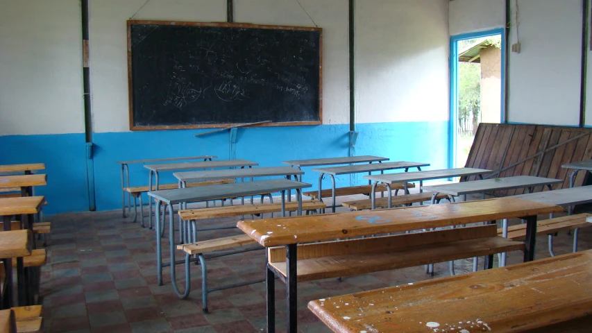 old school classroom with desks and school board