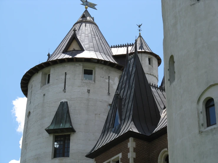 a view of an old building with three tower turrets