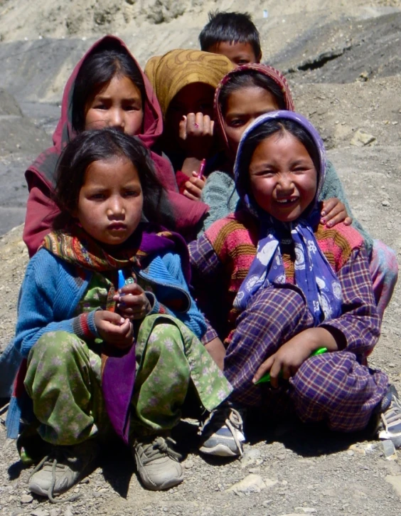 group of girls sitting in a circle on the ground