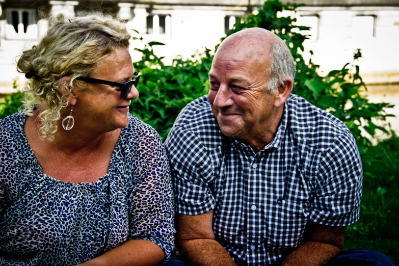 a close up of two people on a bench