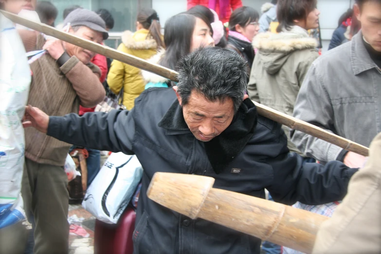 a man holding a giant wooden baseball bat with his hands