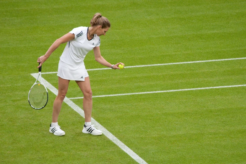 a woman with tennis racquet on tennis court