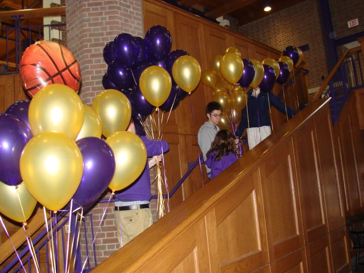 a bunch of balloons that are on the rail