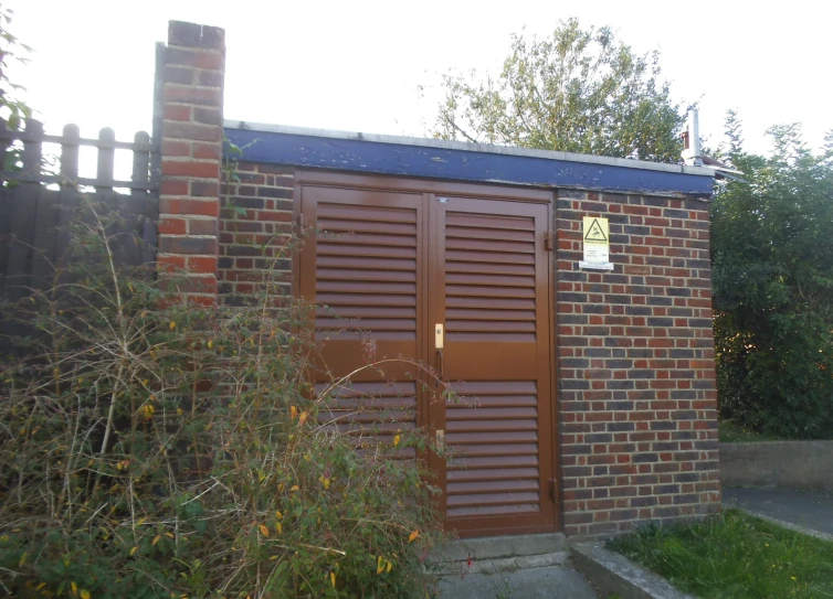 there is a brick building with a wooden door