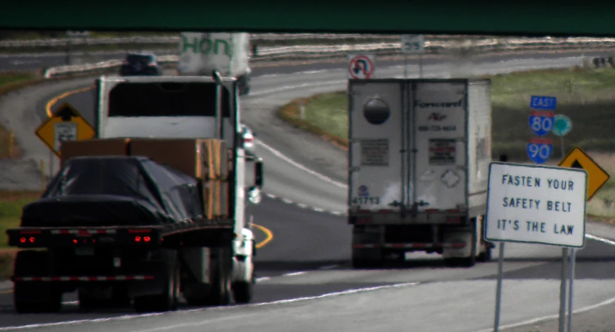 the trucks are waiting on the road for traffic