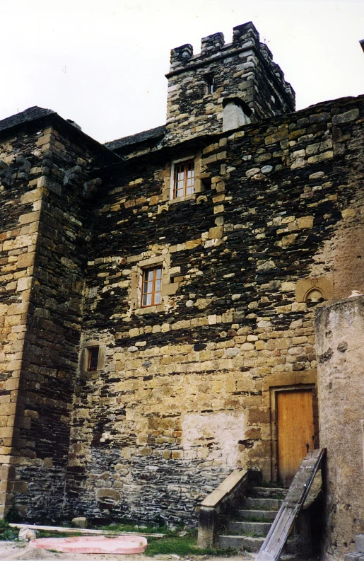 an old stone structure with a few windows