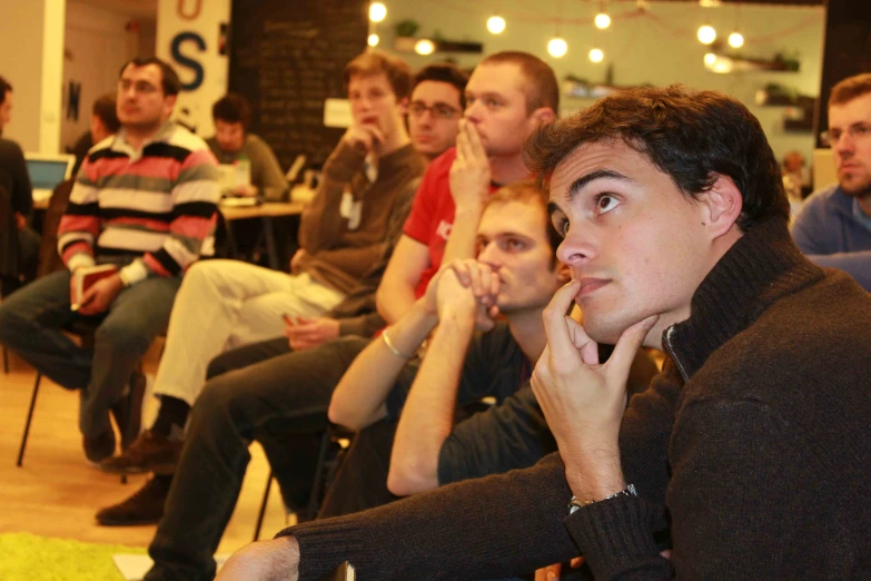 a group of young men sitting next to each other