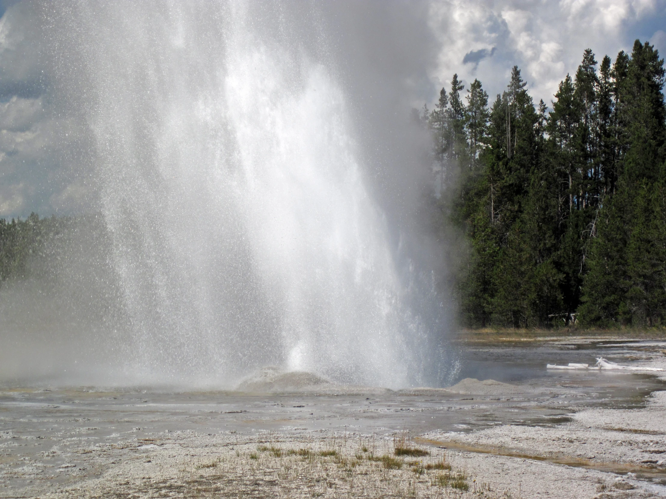 a waterfall pouring out of the middle of a river