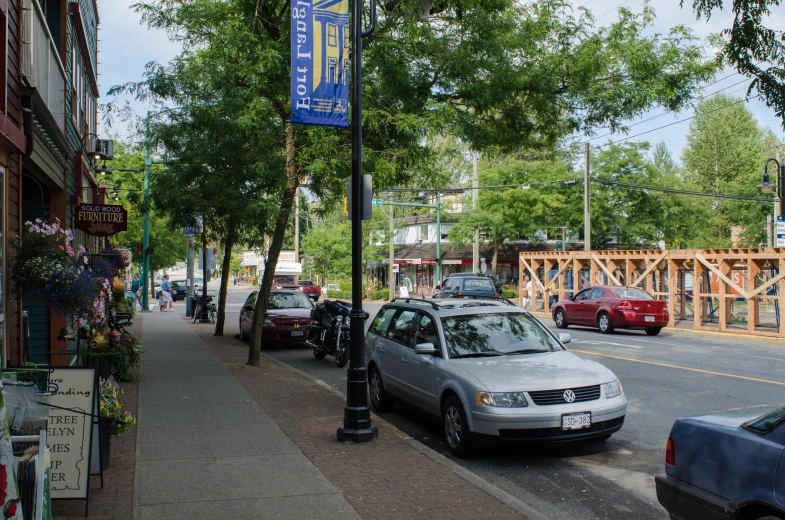 some parked cars sitting on the side of a road