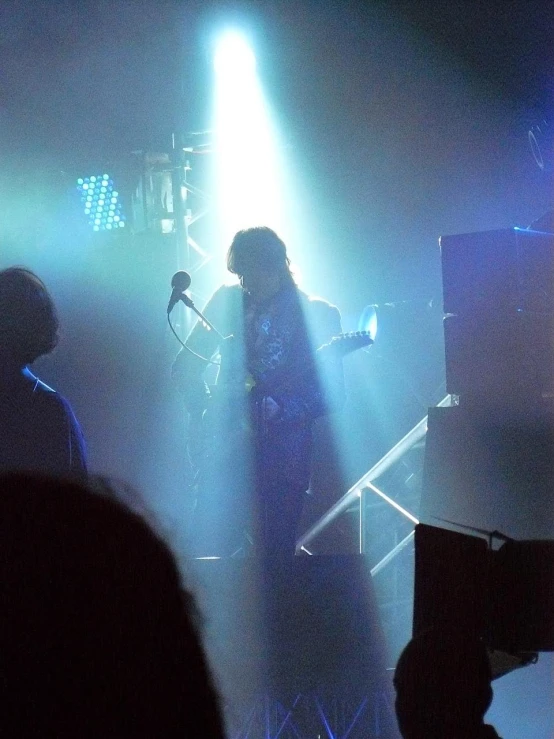 a person playing on a keyboard in front of a crowd