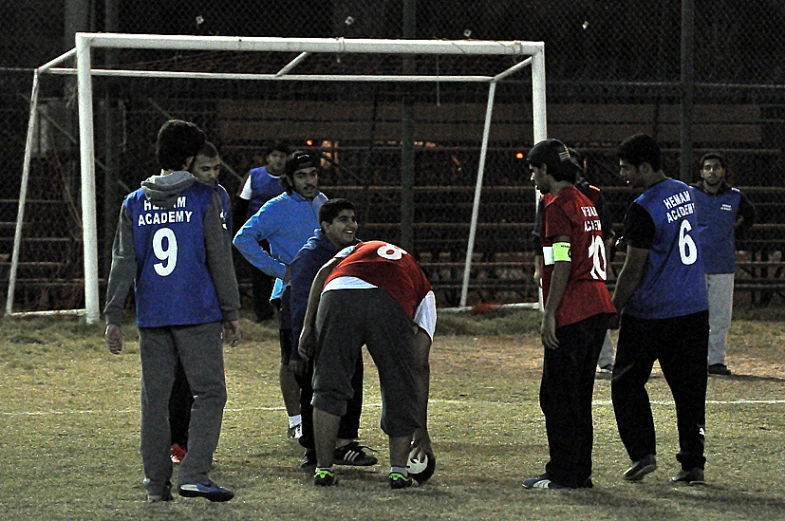 a group of people on a field near a goal