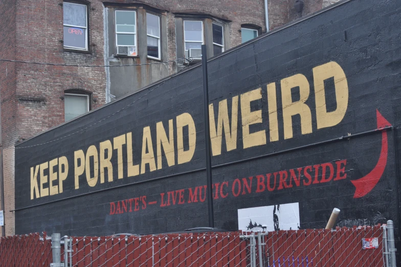 a large mural of the words keep portland weird painted on a side wall