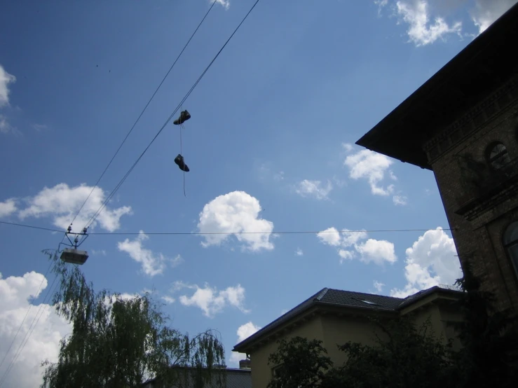 a pair of sneakers hanging from a wire