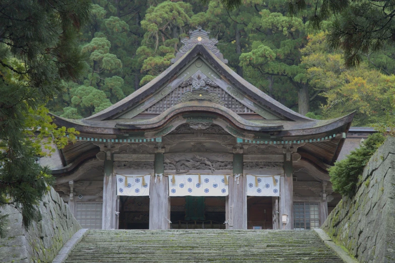 a building with steps leading to it in front of trees