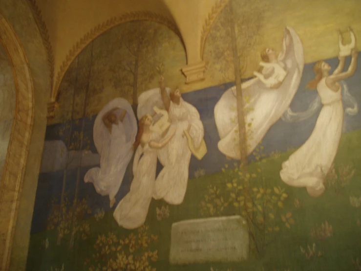 a mural on the side of a building depicting four angels