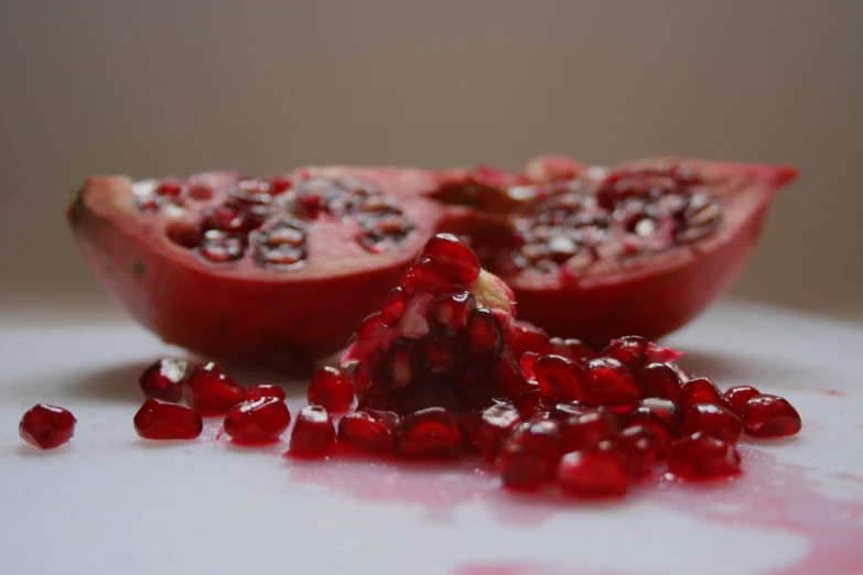 pomegranate falling off a pomegranate on a plate