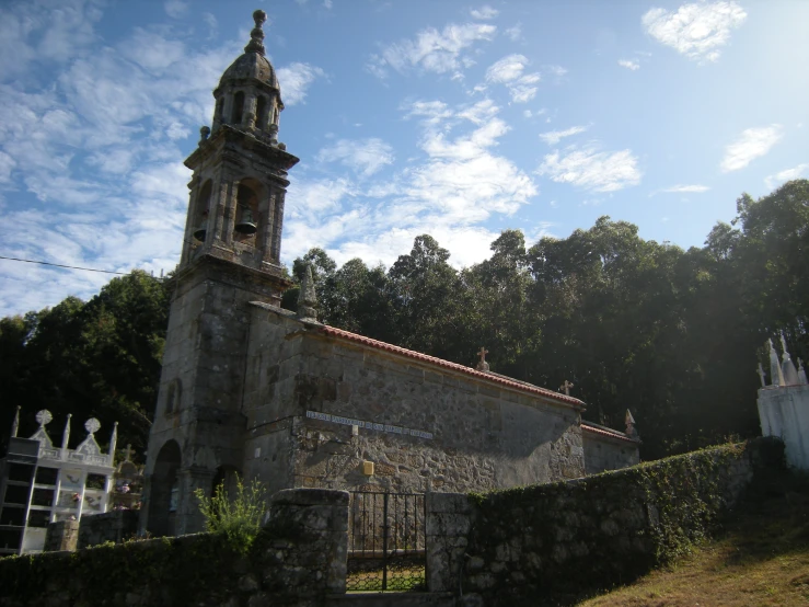 the church is next to some trees and other plants