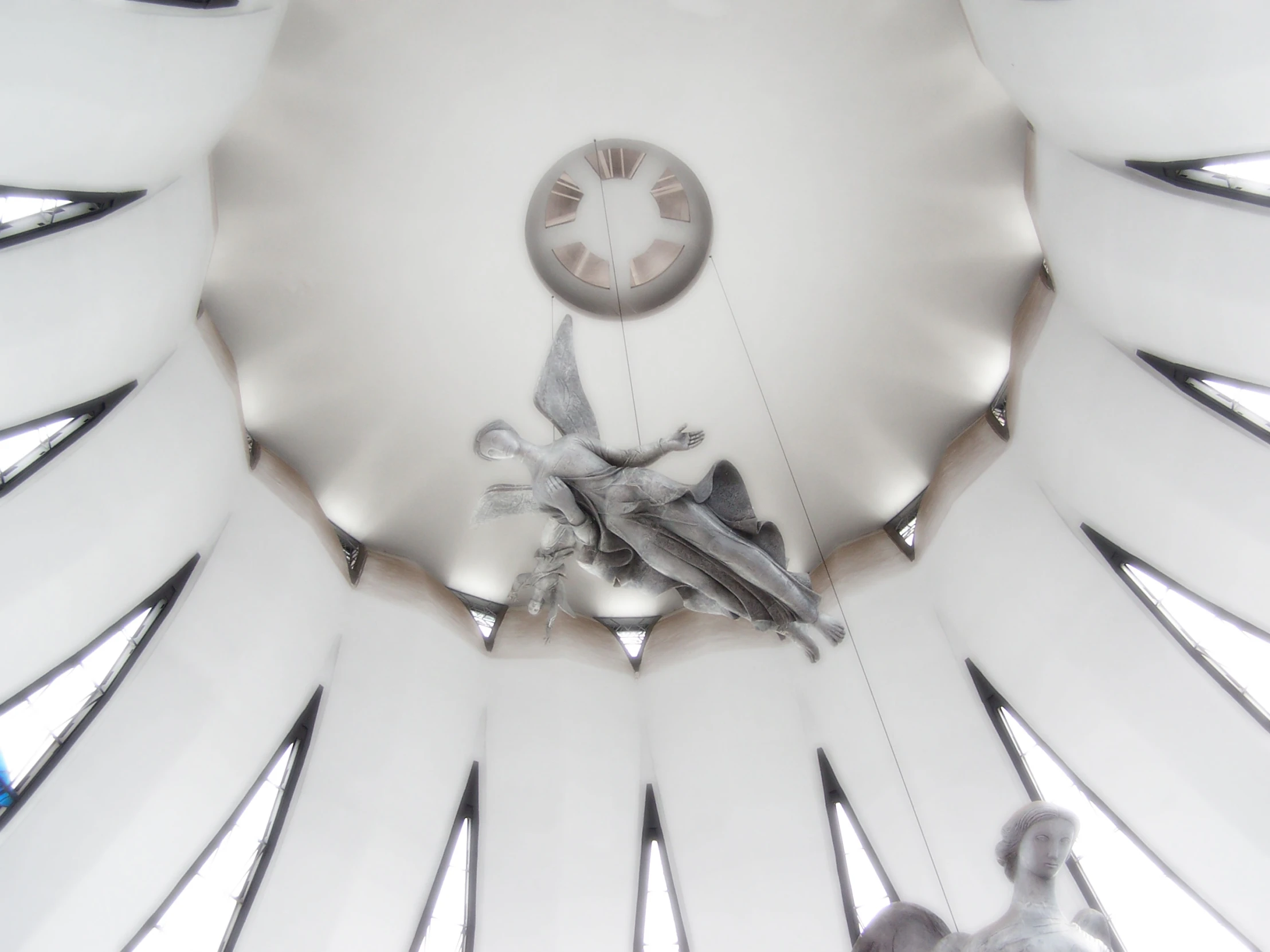 an ornate clock mounted to the ceiling in a room