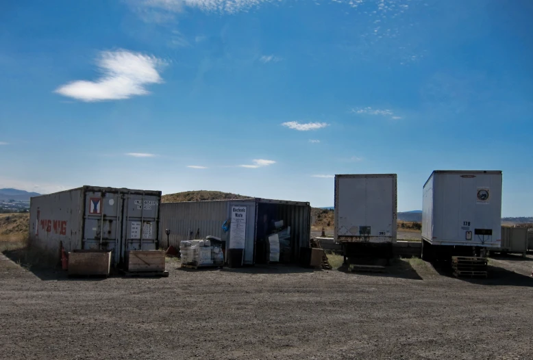 there are several containers that are in the middle of the field