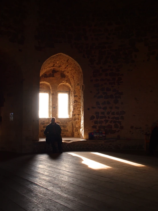 a man sitting on the floor of a room in a building