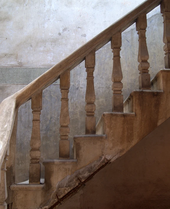 the old man walks down the staircase carrying his luggage