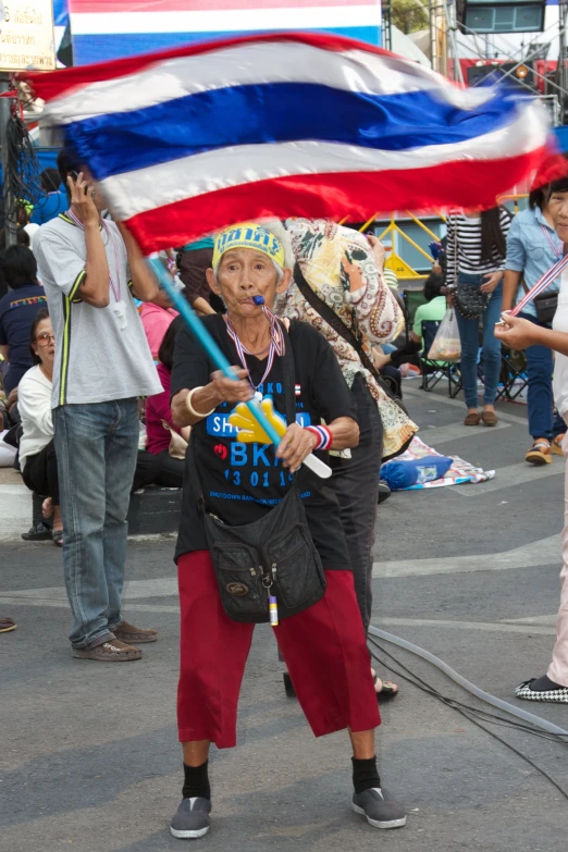 a person holding an american flag behind their back