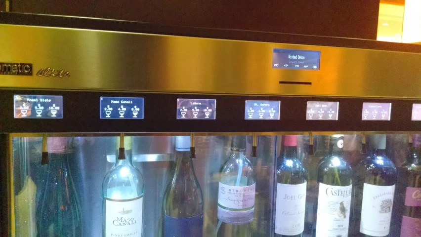 a bunch of wine bottles are in a glass case