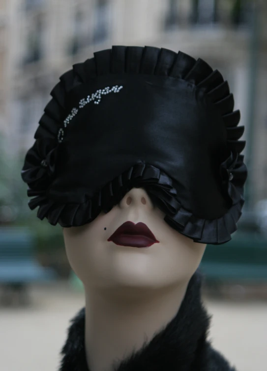 a woman's hat is worn as a sleeping mask
