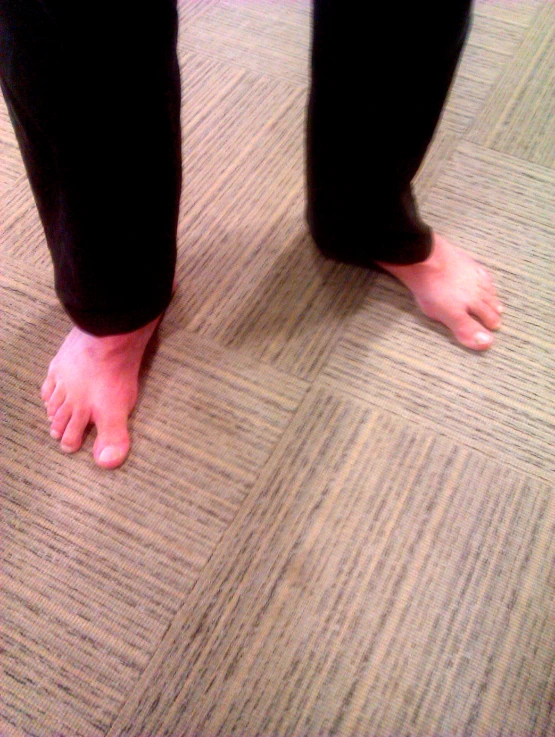 person standing on the floor with their bare feet